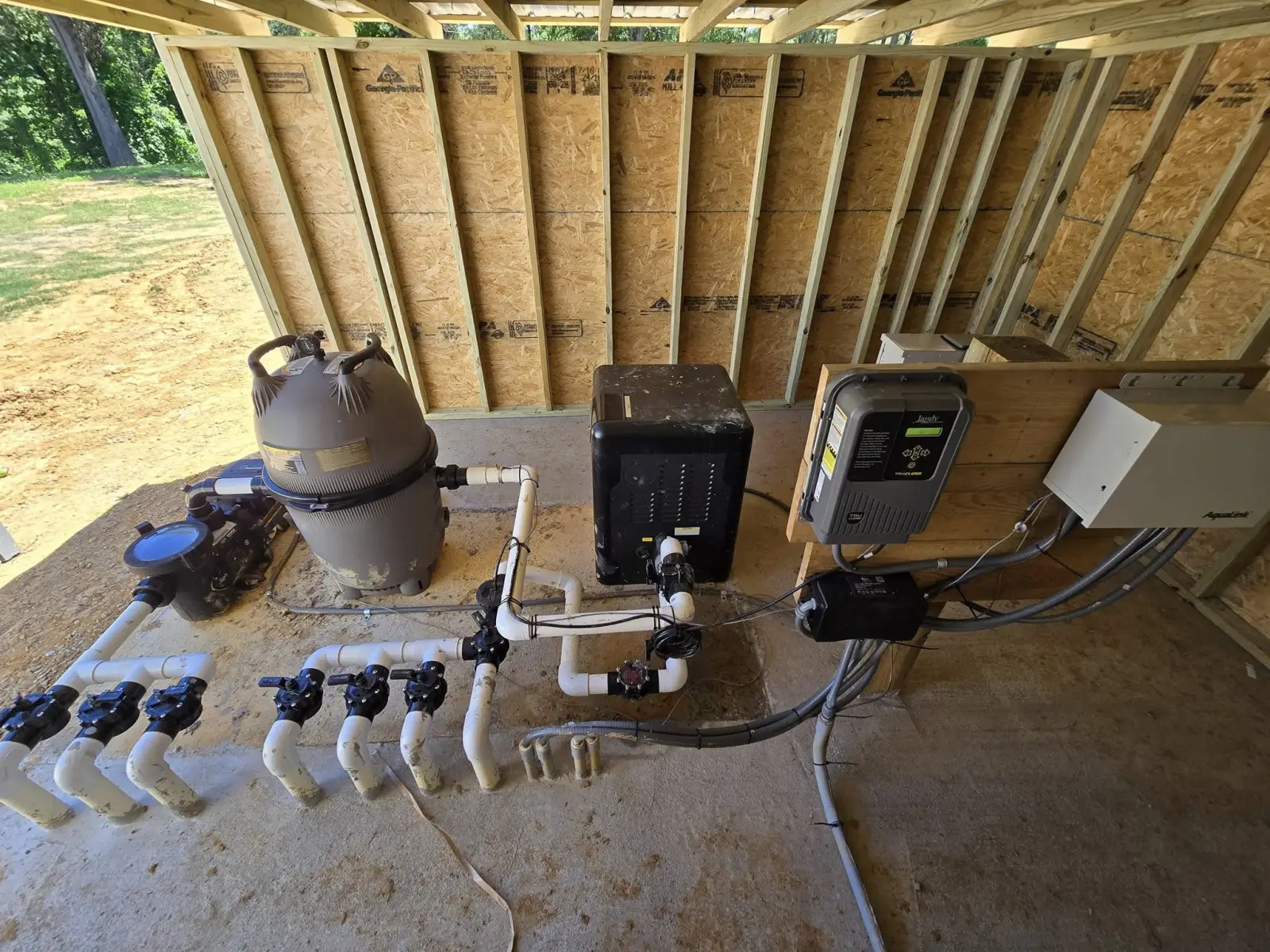 New pool equipment pad with pump, filter and heater