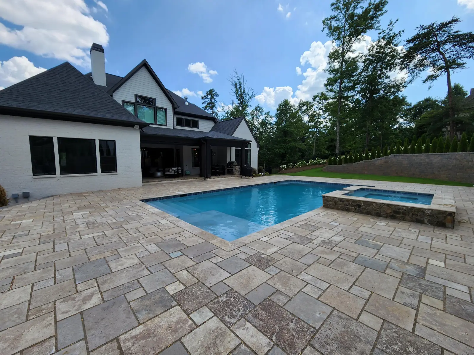 Gunite pool with attached spa and paver deck