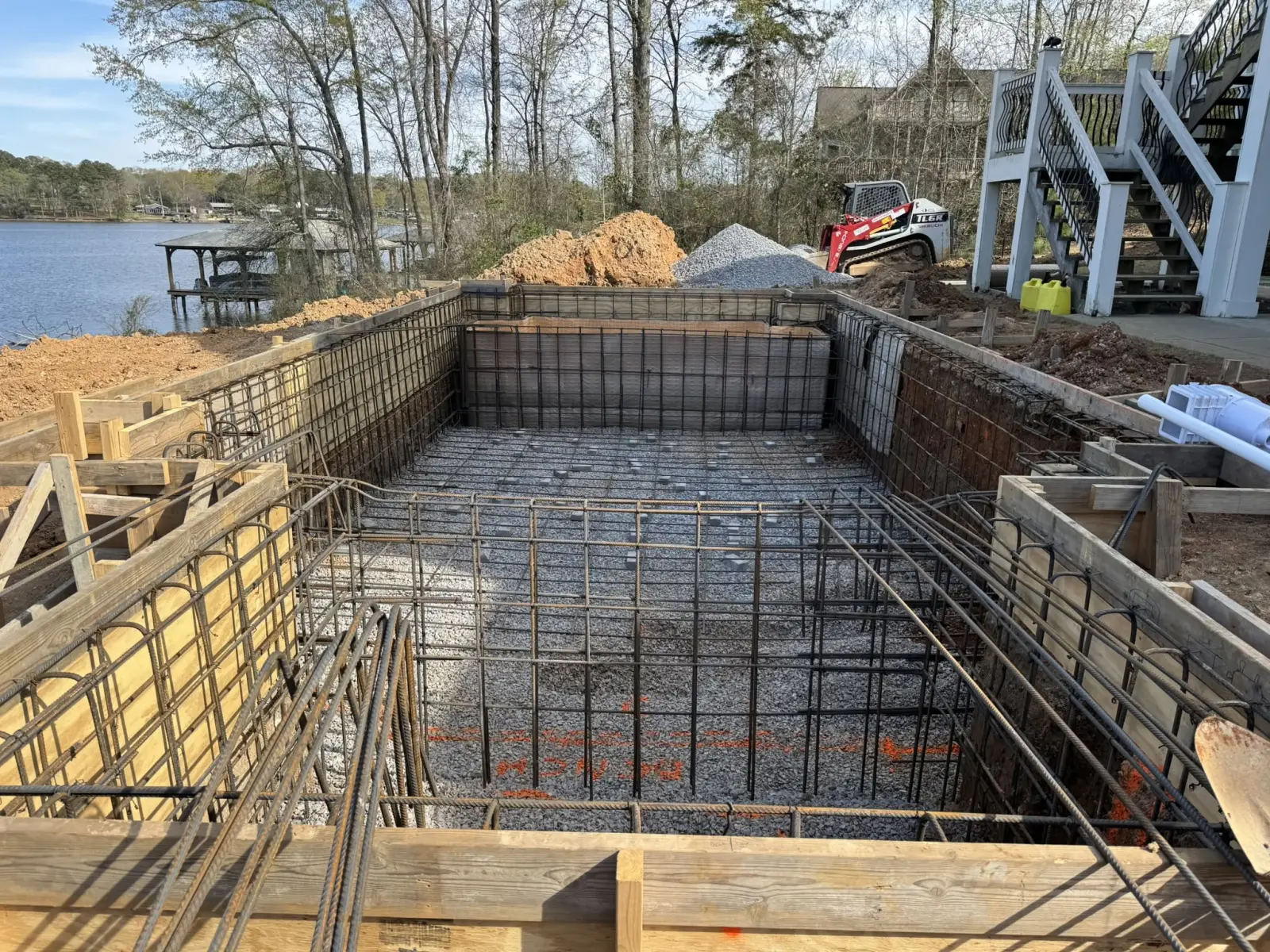Steel walls and rebar of a lakefront pool on Logan Martin Lake